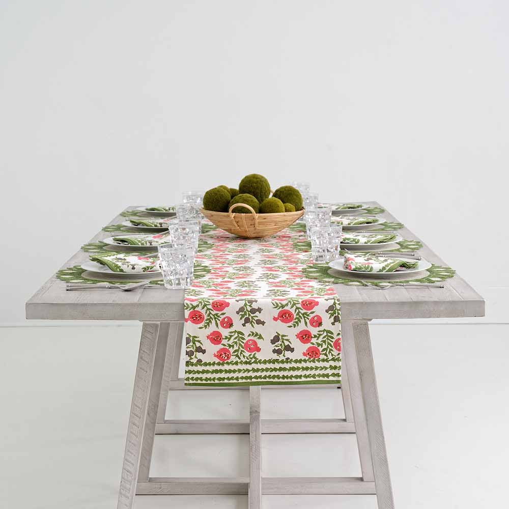 Pom Bells Fern & Poppy table runner decorating middle of table. 