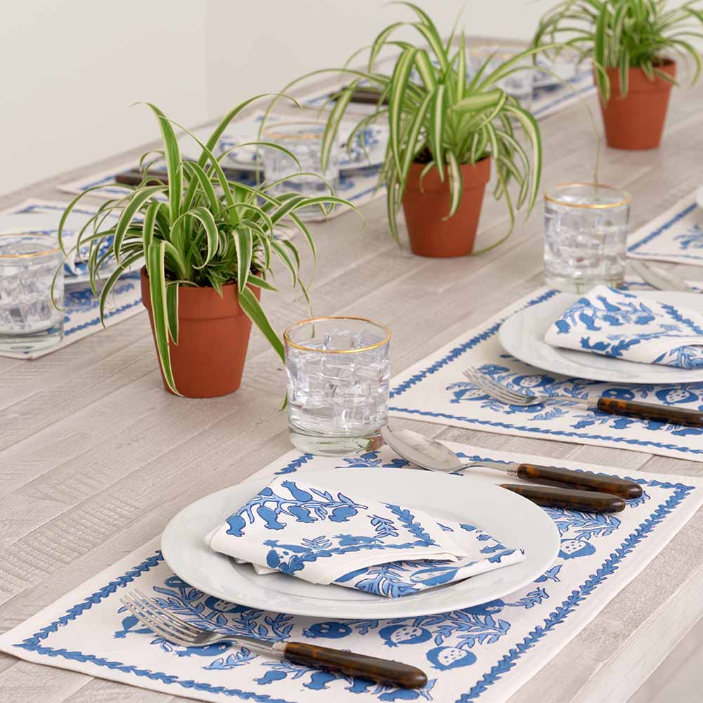 Side view of Pom Bells Wedgewood napkin and matching placemat. 