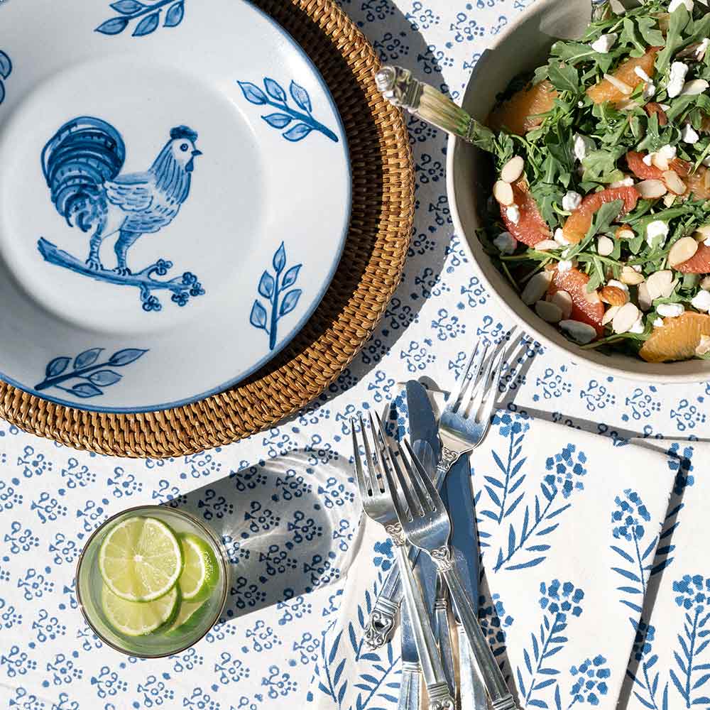 Close up of tablecloth, napkins, plate, and salad. 