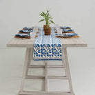 Overview of dinner table with Ginkgo Blue table runner decorating the center. 