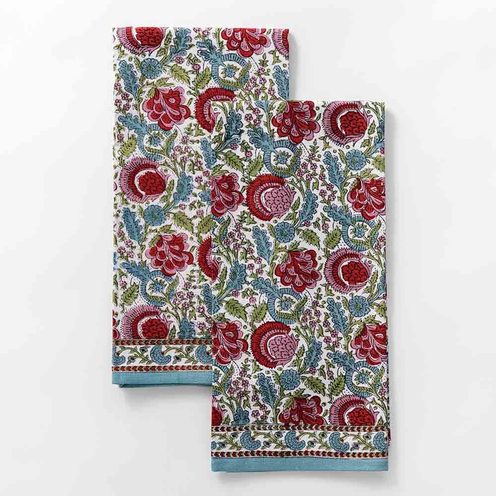 Tea towels designed in turquoise, cranberry red, pink, and aqua as a floral hand blocked cotton print. 