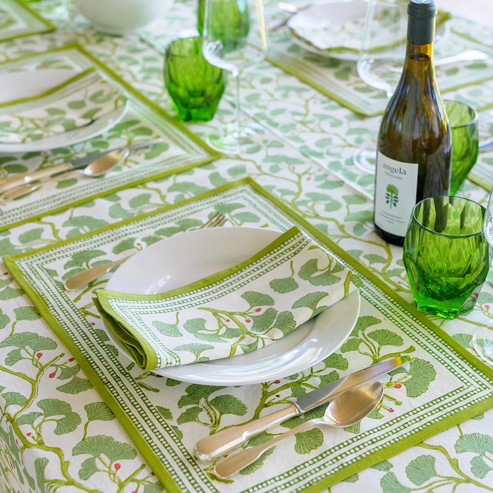 Spring Ginkgo Placemat on table with wine bottle and green glasses.