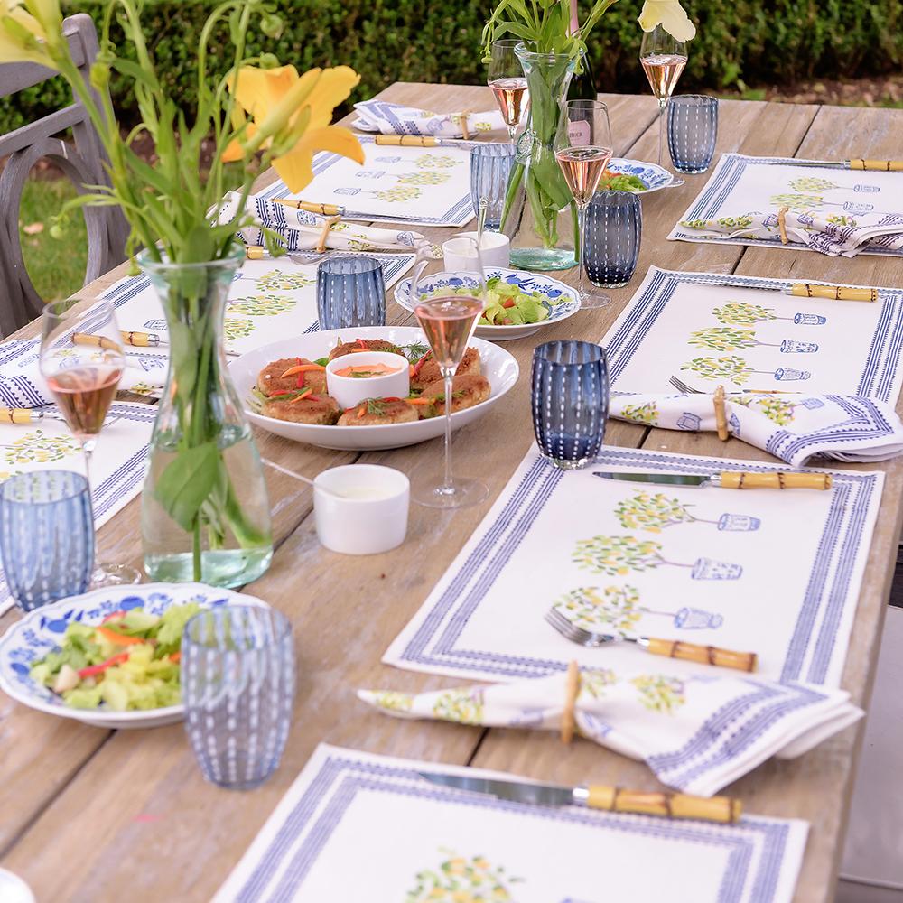 Lemon Topiary Placemat on wooden table in garden setting.