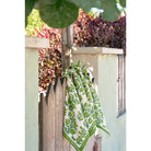 Napkins hanging tied on fence. 