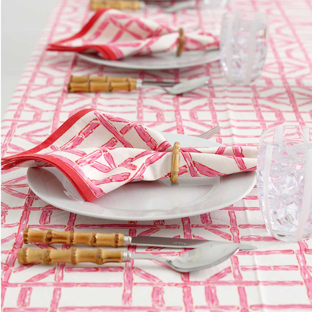 Rose Bamboo napkin in napkin ring on plate. 