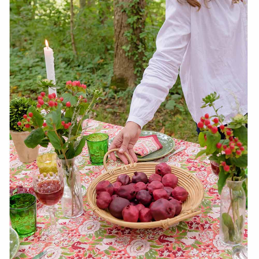 Spice Route Garnet Tablecloth and bamboo bowl filled with fruit.