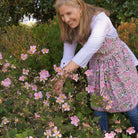 Model wearing Bohemian Floral Moss Green & Mauve Pink apron 