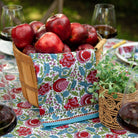 bohemian floral turquoise and cranberry tea towel hanging from bucket of apples