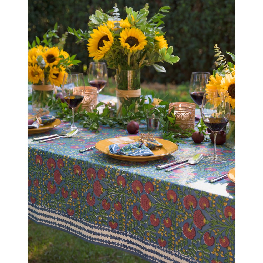 Cactus Flower Midnight Dark Blue & Magenta Floral Tablecloth outdoors set with yellow plates and sunflowers