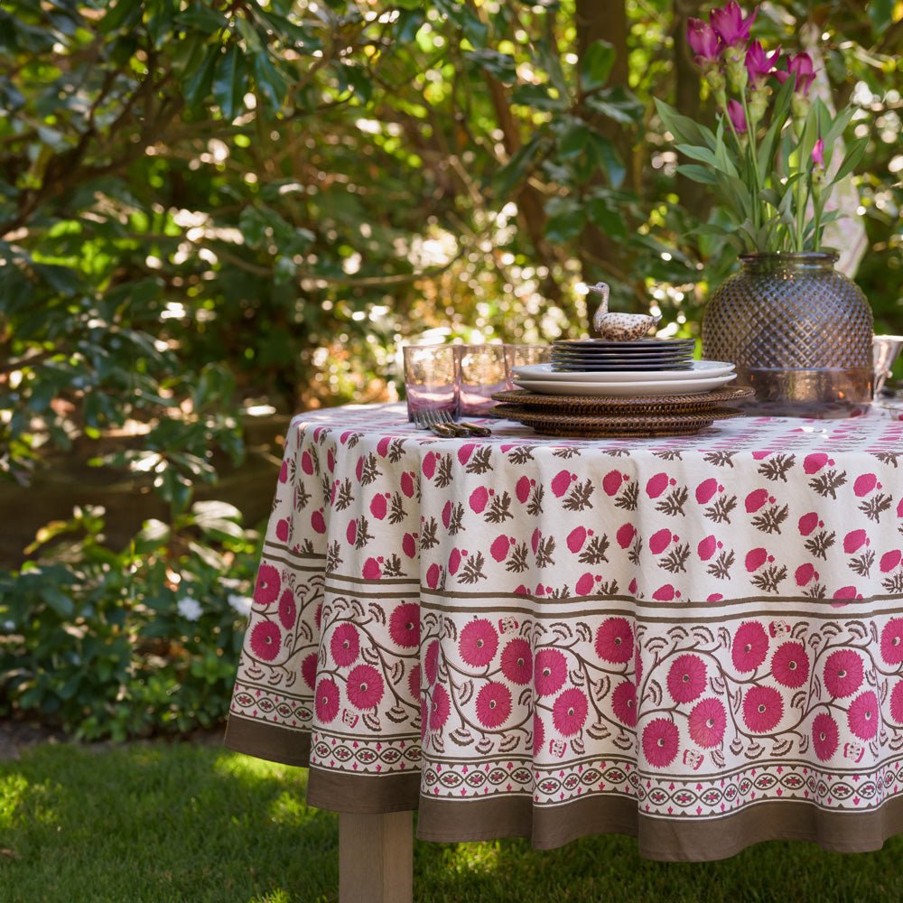 Gaya Fuchsia Pink and Brown Floral tablecloth on round table outdoors