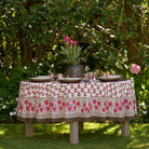 Gaya Fuchsia Pink and Brown Floral tablecloth on round table outdoors