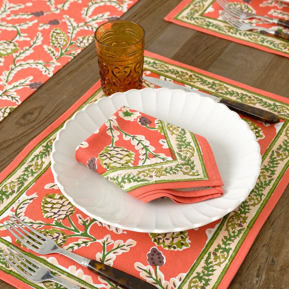 Harvest Pinecone orange & green floral napkin on white plate with matching placemat