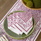 Tapestry eggplant purple & white napkins on. green plate with matching table runner