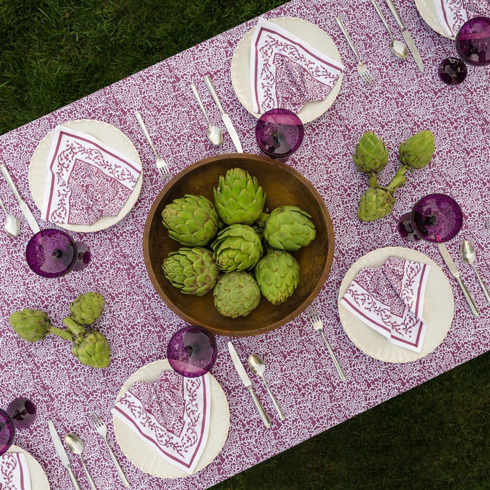 overhead view of tapestry eggplant purple and white tablecloth with matching napkins