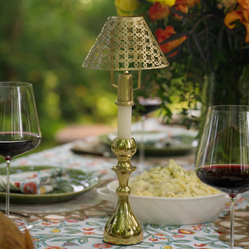 gold candlestick and cutwork shade