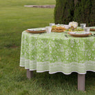 round outdoor table with pomegranate green tablecloth