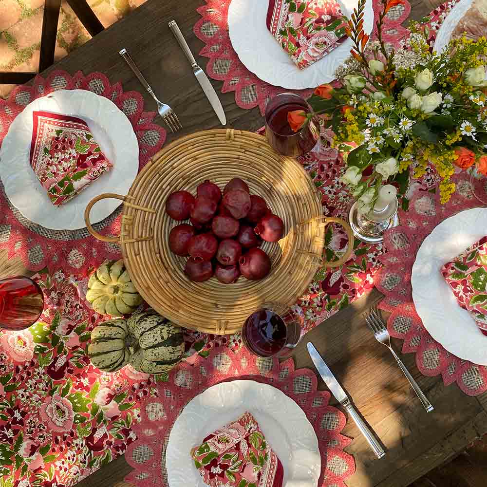 Spice Route Garnet Red Napkin on fall table with fruit and flowers.