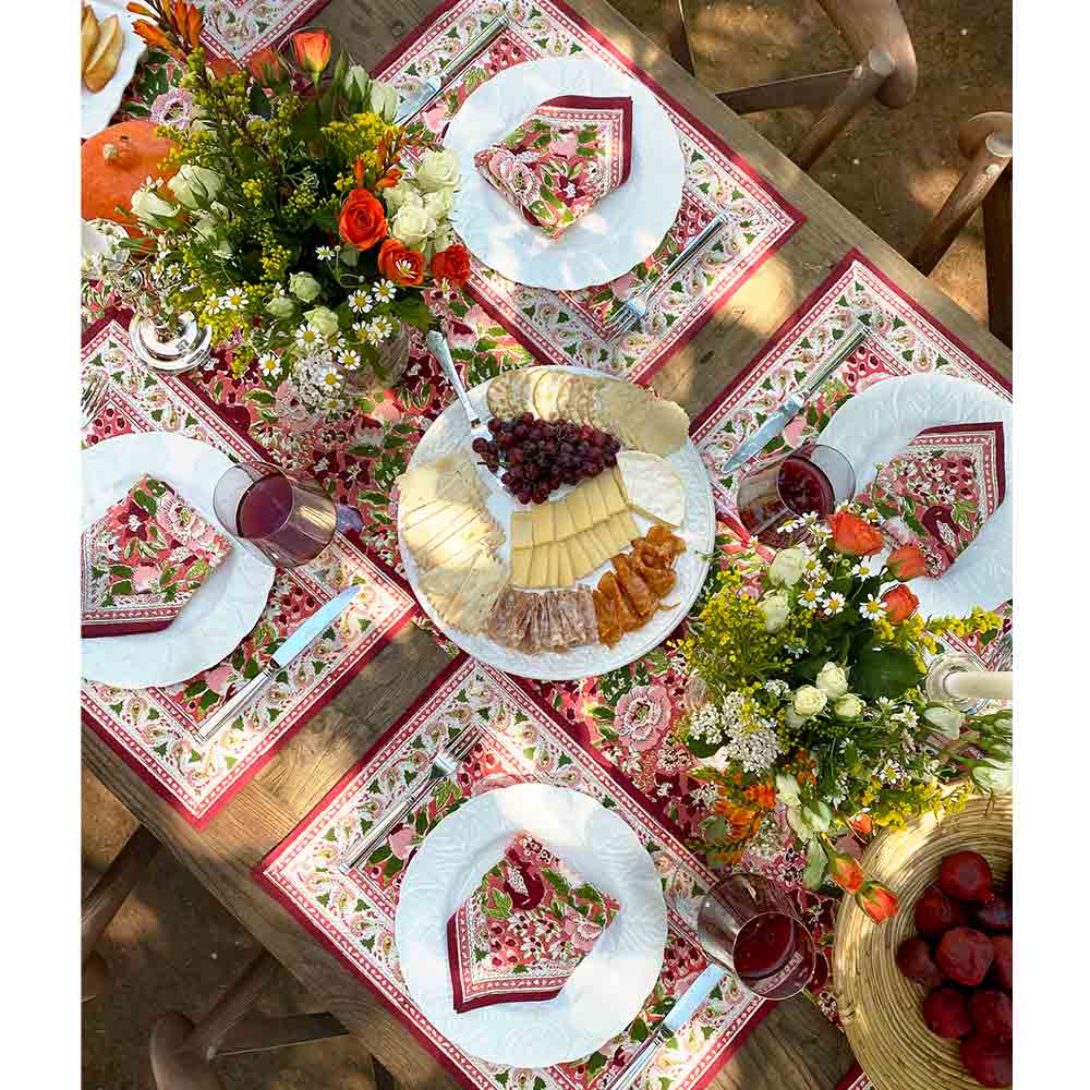 Overhead view of table with flowers, food, and wine. 