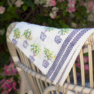 Table runner draped over wicker chair. 