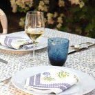 Lemon Topiary Napkin on white plates.