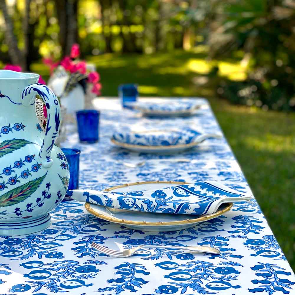 Pom Bells Wedgewood Tablecloth with plates and pitcher.